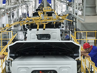 Workers work on an automobile production line at BYD Industrial Co LTD in Huai'an, China, on August 26, 2024. (