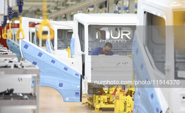 A worker works on an automobile production line at BYD Industrial Co LTD in Huai'an, China, on August 26, 2024. 