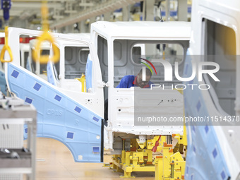 A worker works on an automobile production line at BYD Industrial Co LTD in Huai'an, China, on August 26, 2024. (