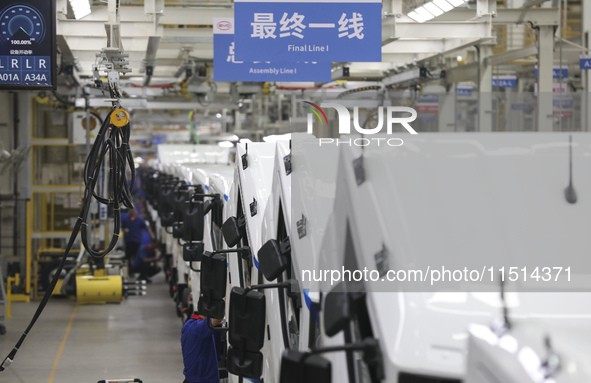 A worker works on an automobile production line at BYD Industrial Co LTD in Huai'an, China, on August 26, 2024. 