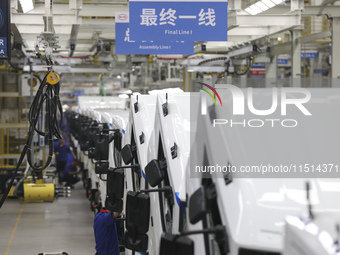 A worker works on an automobile production line at BYD Industrial Co LTD in Huai'an, China, on August 26, 2024. (