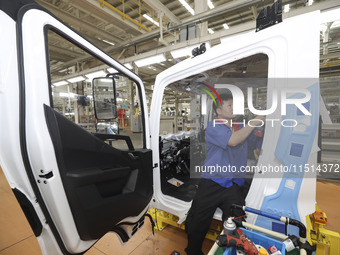 A worker works on an automobile production line at BYD Industrial Co LTD in Huai'an, China, on August 26, 2024. (