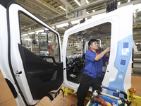 A worker works on an automobile production line at BYD Industrial Co LTD in Huai'an, China, on August 26, 2024. (