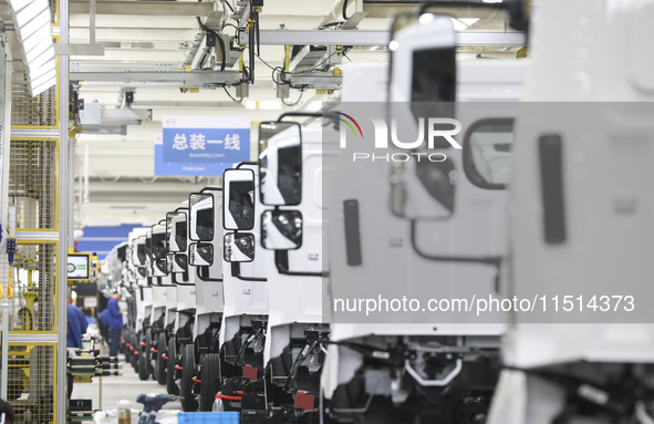 A worker works on an automobile production line at BYD Industrial Co LTD in Huai'an, China, on August 26, 2024. 