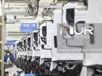 A worker works on an automobile production line at BYD Industrial Co LTD in Huai'an, China, on August 26, 2024. (