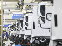 A worker works on an automobile production line at BYD Industrial Co LTD in Huai'an, China, on August 26, 2024. (