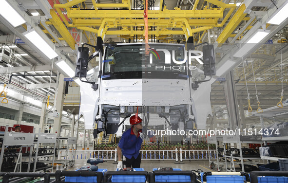 A worker works on an automobile production line at BYD Industrial Co LTD in Huai'an, China, on August 26, 2024. 