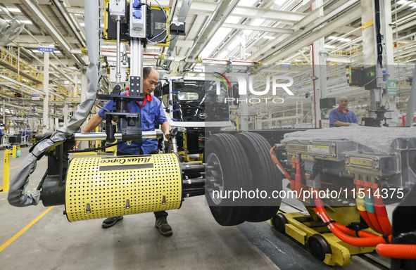 A worker works on an automobile production line at BYD Industrial Co LTD in Huai'an, China, on August 26, 2024. 