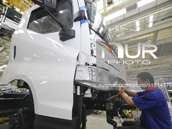 A worker works on an automobile production line at BYD Industrial Co LTD in Huai'an, China, on August 26, 2024. (