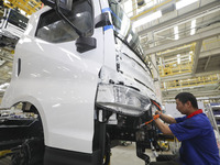 A worker works on an automobile production line at BYD Industrial Co LTD in Huai'an, China, on August 26, 2024. (