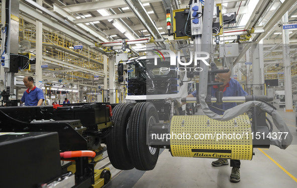 A worker works on an automobile production line at BYD Industrial Co LTD in Huai'an, China, on August 26, 2024. 