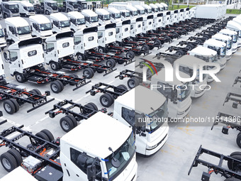 New energy commercial vehicles are produced by BYD Industrial Co., Ltd. in Huai'an, China, on August 26, 2024. (