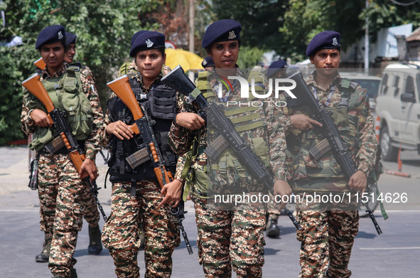 Women Indian paramilitary troopers guard as Kashmiri Hindus celebrate the Janmashtami festival that marks the birthday of Hindu god Krishna...