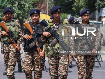 Women Indian paramilitary troopers guard as Kashmiri Hindus celebrate the Janmashtami festival that marks the birthday of Hindu god Krishna...