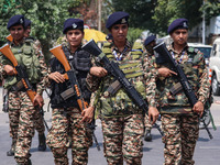 Women Indian paramilitary troopers guard as Kashmiri Hindus celebrate the Janmashtami festival that marks the birthday of Hindu god Krishna...