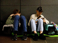 People with their pets in carriers wait out an air raid alarm at the Teatralna metro station during the massive Russian drone and missile at...