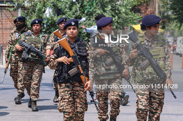 Women Indian paramilitary troopers guard as Kashmiri Hindus celebrate the Janmashtami festival that marks the birthday of Hindu god Krishna...