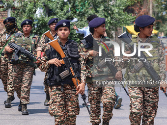 Women Indian paramilitary troopers guard as Kashmiri Hindus celebrate the Janmashtami festival that marks the birthday of Hindu god Krishna...