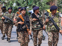 Women Indian paramilitary troopers guard as Kashmiri Hindus celebrate the Janmashtami festival that marks the birthday of Hindu god Krishna...