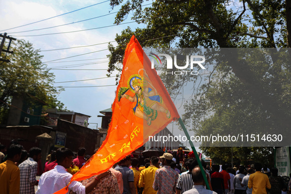 A Hindu devotee waves a religious flag during the Janmashtami festival that marks the birthday of the Hindu god Krishna with a procession in...