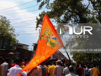 A Hindu devotee waves a religious flag during the Janmashtami festival that marks the birthday of the Hindu god Krishna with a procession in...