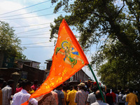 A Hindu devotee waves a religious flag during the Janmashtami festival that marks the birthday of the Hindu god Krishna with a procession in...