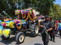 Indian policemen guard as Kashmiri Hindus celebrate the Janmashtami festival that marks the birthday of Hindu god Krishna with a procession...