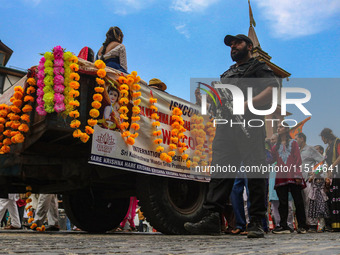 An Indian policeman guards as Kashmiri Hindus celebrate the Janmashtami festival that marks the birthday of the Hindu god Krishna with a pro...