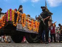 An Indian policeman guards as Kashmiri Hindus celebrate the Janmashtami festival that marks the birthday of the Hindu god Krishna with a pro...