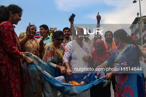 Hindu devotees celebrate the Janmashtami festival that marks the birthday of the Hindu god Krishna with a procession in Srinagar, Jammu and...