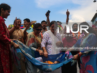 Hindu devotees celebrate the Janmashtami festival that marks the birthday of the Hindu god Krishna with a procession in Srinagar, Jammu and...