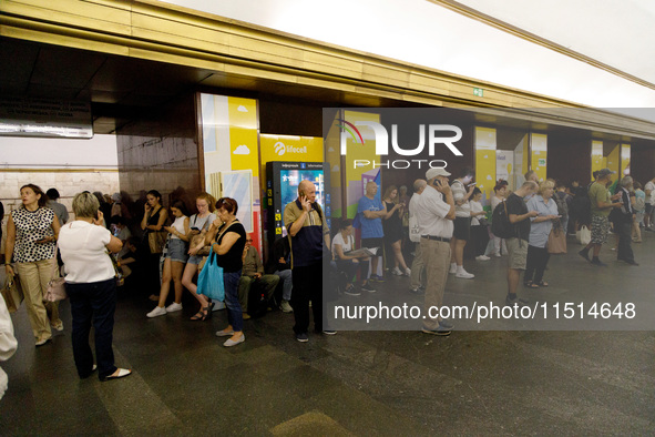 People wait out an air raid alarm at the Teatralna metro station during the massive Russian drone and missile attack on Ukraine in Kyiv, Ukr...