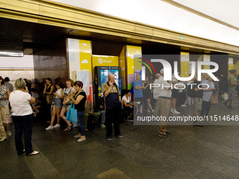 People wait out an air raid alarm at the Teatralna metro station during the massive Russian drone and missile attack on Ukraine in Kyiv, Ukr...