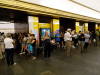 People wait out an air raid alarm at the Teatralna metro station during the massive Russian drone and missile attack on Ukraine in Kyiv, Ukr...