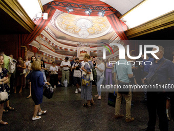 People wait out an air raid alarm at the Teatralna metro station during the massive Russian drone and missile attack on Ukraine in Kyiv, Ukr...