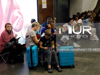 People wait out an air raid alarm at the Teatralna metro station during the massive Russian drone and missile attack on Ukraine in Kyiv, Ukr...