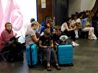 People wait out an air raid alarm at the Teatralna metro station during the massive Russian drone and missile attack on Ukraine in Kyiv, Ukr...