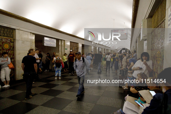 People wait out an air raid alarm at the Khreshchatyk metro station during the massive Russian drone and missile attack on Ukraine in Kyiv,...