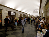 People wait out an air raid alarm at the Khreshchatyk metro station during the massive Russian drone and missile attack on Ukraine in Kyiv,...