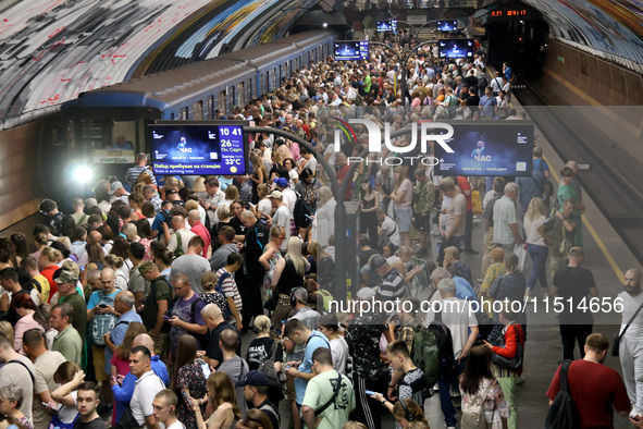 People crowd on the platform during an air raid alarm at the Osokorky metro station during the massive Russian drone and missile attack in K...