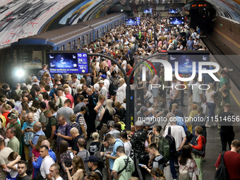 People crowd on the platform during an air raid alarm at the Osokorky metro station during the massive Russian drone and missile attack in K...