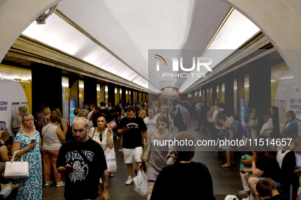 People wait out an air raid alarm at the Teatralna metro station during the massive Russian drone and missile attack on Ukraine in Kyiv, Ukr...