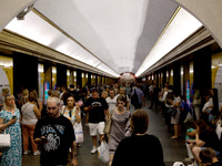 People wait out an air raid alarm at the Teatralna metro station during the massive Russian drone and missile attack on Ukraine in Kyiv, Ukr...