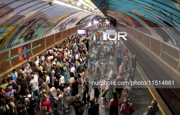 People shelter at the Osokorky metro station during the massive Russian drone and missile attack in Kyiv, Ukraine, on August 26, 2024. NO US...