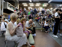 People wait out an air raid alarm at the Pozniaky metro station during the massive Russian drone and missile attack on Ukraine in Kyiv, Ukra...