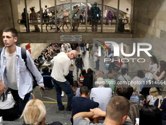 People shelter at the Osokorky metro station during the massive Russian drone and missile attack in Kyiv, Ukraine, on August 26, 2024. NO US...