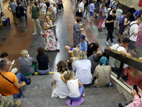 People wait out an air raid alarm at the Pozniaky metro station during the massive Russian drone and missile attack on Ukraine in Kyiv, Ukra...