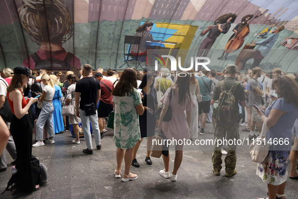 People shelter at the Osokorky metro station during the massive Russian drone and missile attack in Kyiv, Ukraine, on August 26, 2024. NO US...