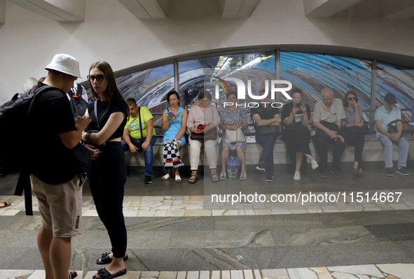 People shelter at the Osokorky metro station during the massive Russian drone and missile attack in Kyiv, Ukraine, on August 26, 2024. NO US...