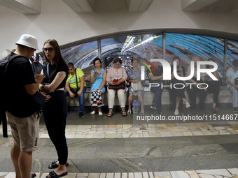 People shelter at the Osokorky metro station during the massive Russian drone and missile attack in Kyiv, Ukraine, on August 26, 2024. NO US...